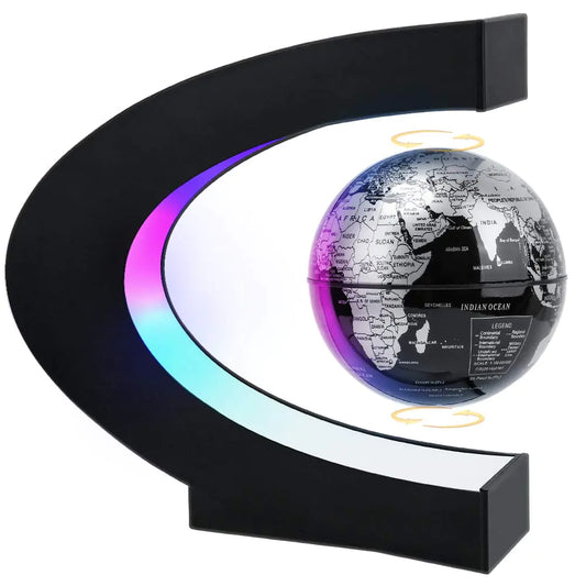 A 3.5-inch magnetic levitating globe floating inside a C-shaped black frame with purple and cyan LED lights on a modern office desk.