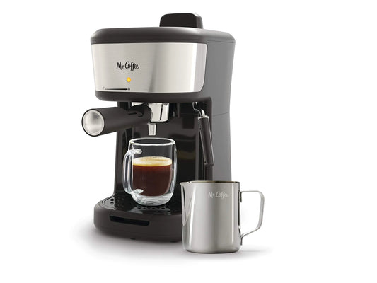 A sleek Mr. Coffee 4-Shot Steam Espresso and Cappuccino Maker in black and stainless steel with an integrated milk frothing wand and frothing pitcher.